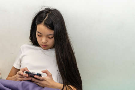 An Asian long haired girl wearing a black mask is ill with the flu. On a white background.Clipping pathの写真素材