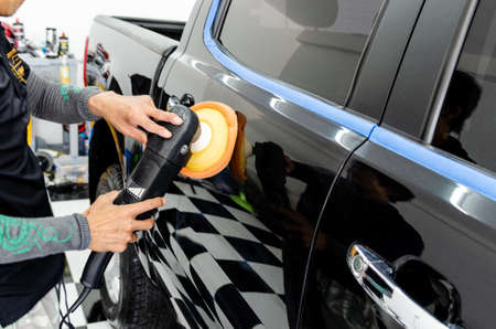 Man hands holding the work tool polish the car.Buffing and polishing car. Car detailing.の写真素材