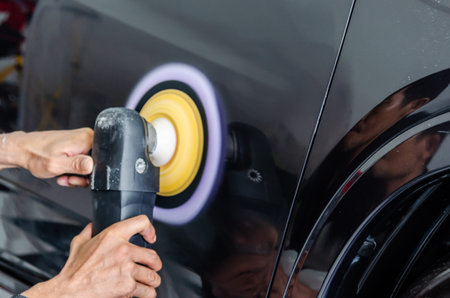 Man hands holding the work tool polish the car.Buffing and polishing car. Car detailing.