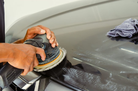 Car detailing - Man hands holding the work tool polish the car.Buffing and polishing car.