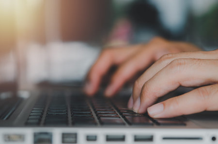 Close up businessman hand typing a computer laptop keyboard.Work using a computer, searching the...