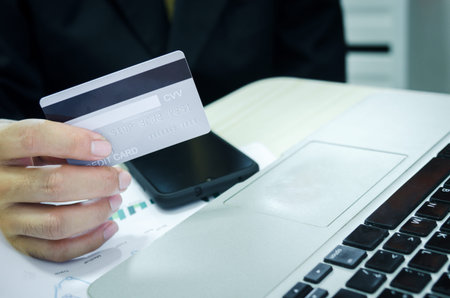 Online shopping by credit card with computer.