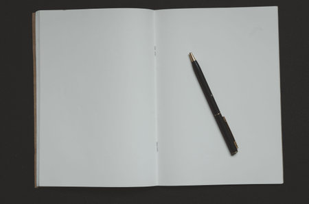 top view book and pen on black background.の写真素材