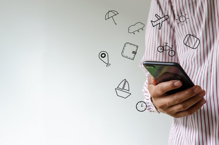 Hand holding smartphone with icons travel concept.