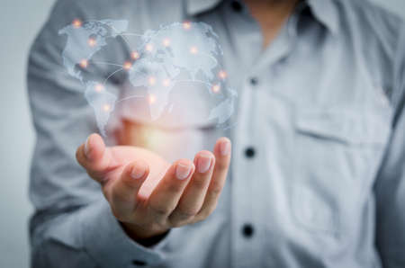 Businessman holding in hand with global networks communicate.Element of this image furnished by Nasaの写真素材