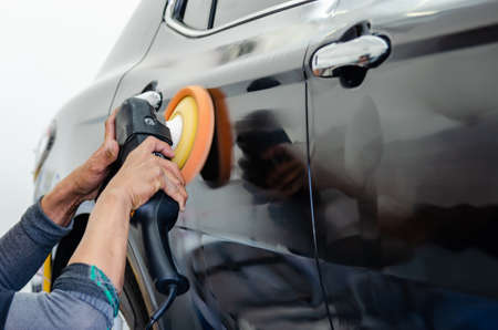 Man working for polishing, coating cars. polishing of the car will help eliminate contaminants on the surface of the car.の写真素材