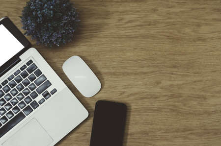 Modern office desk table with Office supplies computer laptop , smart phone , tree and mouse on top view and copy space.Flat lay Business concept desk  table style vintage. Work from home.の写真素材