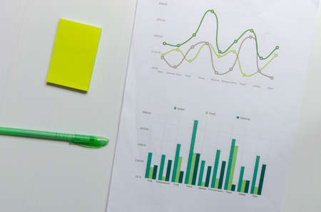Business graph and chart finance, accounting, statistics and analytic research with pen .Business document conceptの写真素材