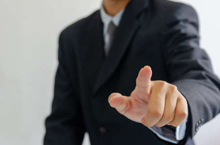 business man wearing a suit pointing fingers in front.の写真素材