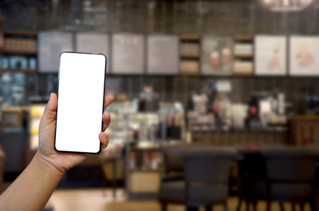 hand holding phone mockup image blank screen for advertising text in supermarket shopping mall...