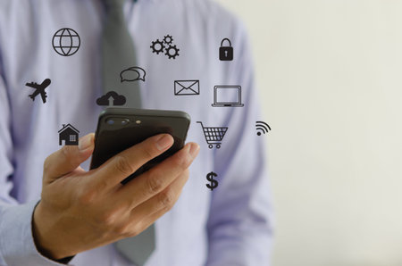 Hand holding smartphone with icons concept. Hand use smartphone online shopping Social media network...