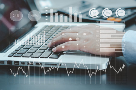 businessman typing computer laptop on desk. chart and graph virtual screen hologram. business...