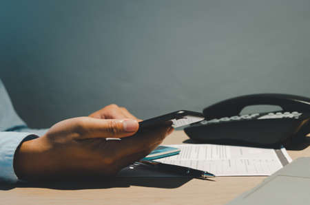 business man hand holding mobile phone.の写真素材