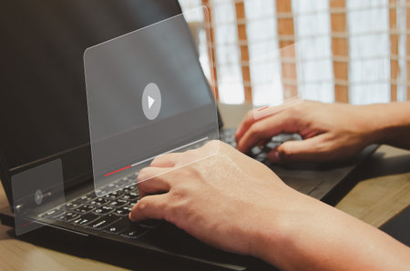 businessman is typing in searches for internet business information at a laptop computer at his...
