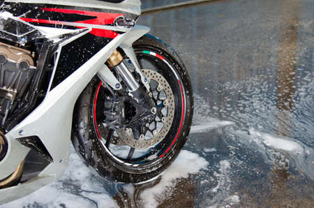 Cleaning the motorbike at the car wash shopの写真素材