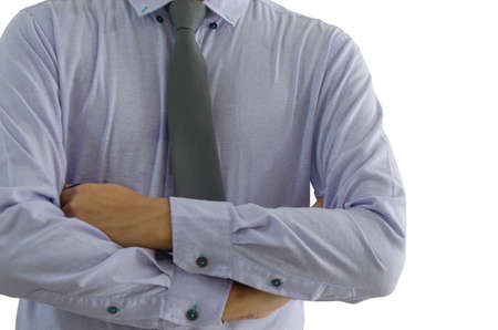 Business man standing with his arms crossed on a white background.の写真素材