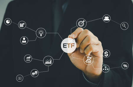 Hand businessman icon ETF Exchange Traded Fund virtual screen Internet Business stock market finance Index Fund Concept.の写真素材