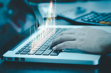 Businessman typing computer laptop and showing graph and char virtual hologram of statistics. Stock market exchange trading graph analysis investment. Business growth, planing and strategy concept.の写真素材
