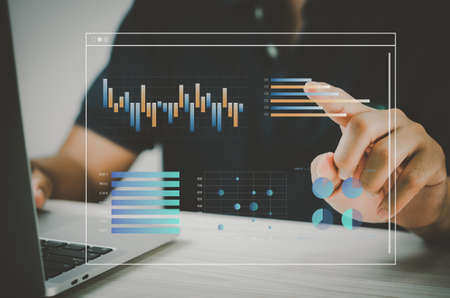 man hand using laptop to working technology.Hand toucing virtual screen graph and chart data analysis and big data business concept.の写真素材