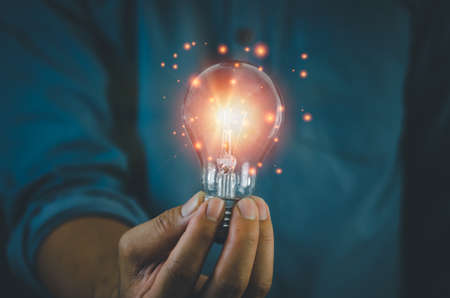hand hold light bulb on black background.Inspiration and Creativity Concepts.の写真素材