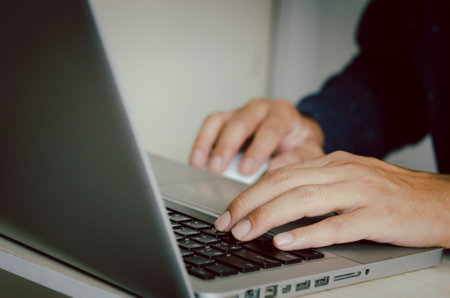 Man hand using a computer to type on a keyboard to find information on the Internet on social networks.の写真素材