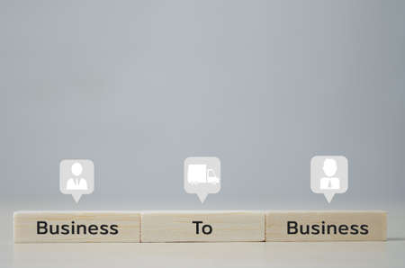 wooden cubes with B2B Business to Business and icons on table and copy space.Business concepts.の写真素材