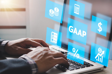 man hand using laptop virtual screen GAAP Generally Accepted Accounting Principles icons and...