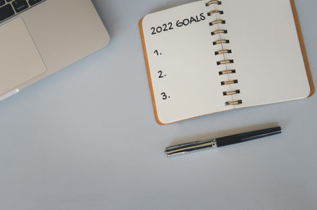 2022 goal notebook and pen on background. Top view copy space.