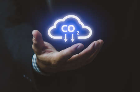 Man hand icon cloud. Sustainable eco energy CO2 emissions and global warming with investment constraints  icons and symbols virtual screen. Business concept.の写真素材
