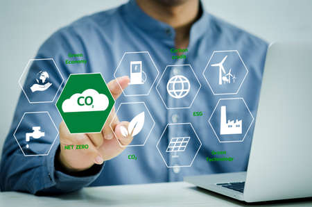 businessman hand touches global warming Renewable energy a virtual screen. Reduce CO2 emissions. Sustainable business development concept.の写真素材