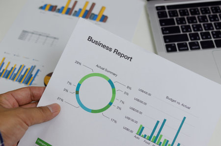 Business document chart report financial and graph statistic analysis management information and research investment plan sale on desk at office.の写真素材