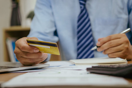 employee of a company paying a charge with a credit card while conducting internet shopping. Concept...