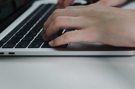 close up hand woman typing keyboard computer laptop on desk.Business technology online and...