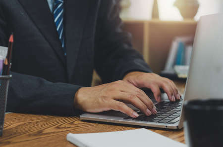 Business typing keyboard computer laptop technology online digital marketing and internet communication social network on table at office.の写真素材