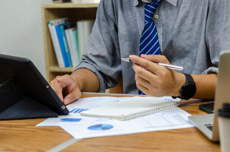 Businessman holding pen document graph accounting finance paper work analysis chart marketing...