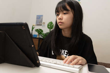 Woman hand using keyboard computer laptop internet communication social network digital technology.の写真素材