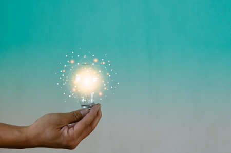 Man holding light bulbs ideas innovation technology and creative business concept.の写真素材