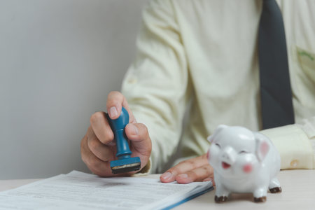 Man stamping approval of work finance banking or investment marketing documents on desk.