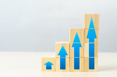 Business financial increase revenue investment with wood cube block on desk concept.の写真素材