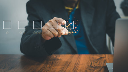 Business people use laptop computers survey and rate satisfaction give a 5 star shape on a virtual...