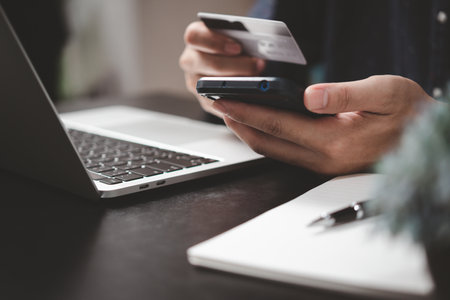 man paying and shopping with smartphone application e commerce wallet app technology. Man using mobile phone and credit card paying via mobile banking.の写真素材