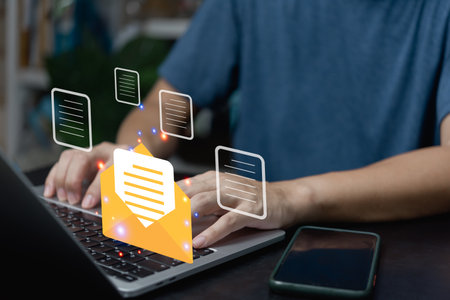 businessman using computer laptop checking email icon online or sending mail to partner and customer on web with virtual interface technology concept.の写真素材
