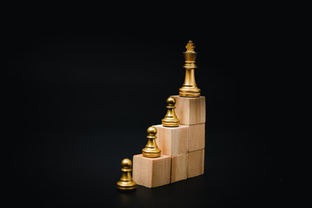 wooden cube and chess, business and marketing strategy concept in planning goals on black background.の写真素材