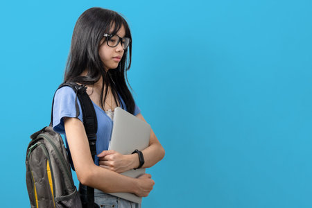 person asian teen girl holding computer laptop on background.Education learning back to school...