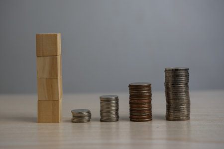Stack coin and wood block cube blank on desk.の写真素材