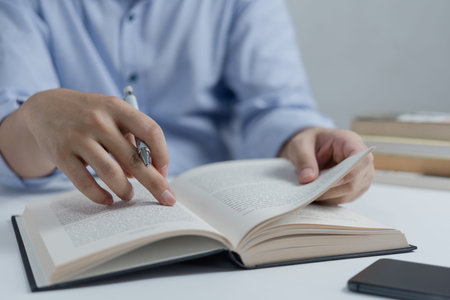 Businessperson reading and writing on book.education studying knowledge development and cognition...