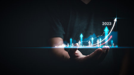 Businessman analyzes 2023 Planning invest indicators performance profitability of working companies with digital virtual screen graphics, businessman financial data investments.の写真素材