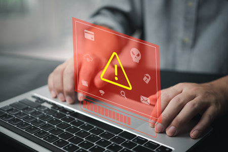 Businessman programmer, developer using laptop computer with triangle caution warning sign. system hacked on computer network cybersecurity vulnerability.の写真素材