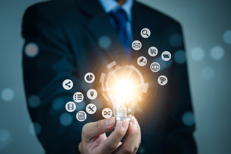 Businessman holding light bulb and new ideas. Creative and inspiration.business with innovative technology network connection. Innovation finance and economic growth concept.の写真素材