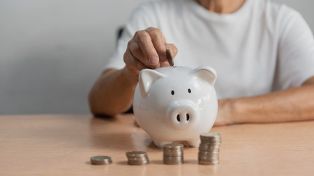 woman putting coin into piggy bank and saving money for future plan and retirement fund earning money or investment or tax for business concept.の写真素材